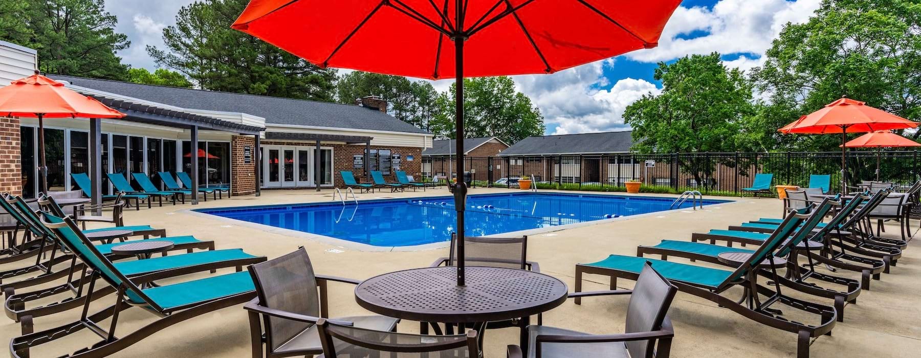 Swimming pool with lounge seating and umbrellas