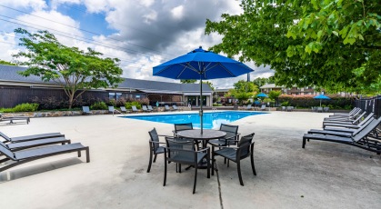Swimming pool with lounge seating and umbrellas