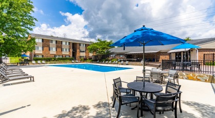 Swimming pool with lounge seating and umbrellas