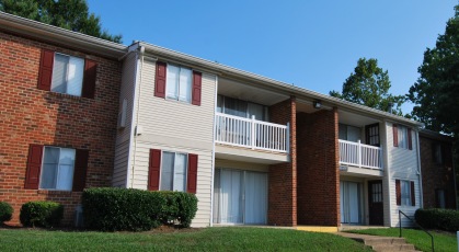 Two story apartment building with attractive landscaping and green lawn