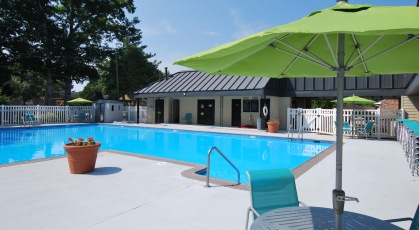 Olympic sized swimming pool with lounge chairs on the deck