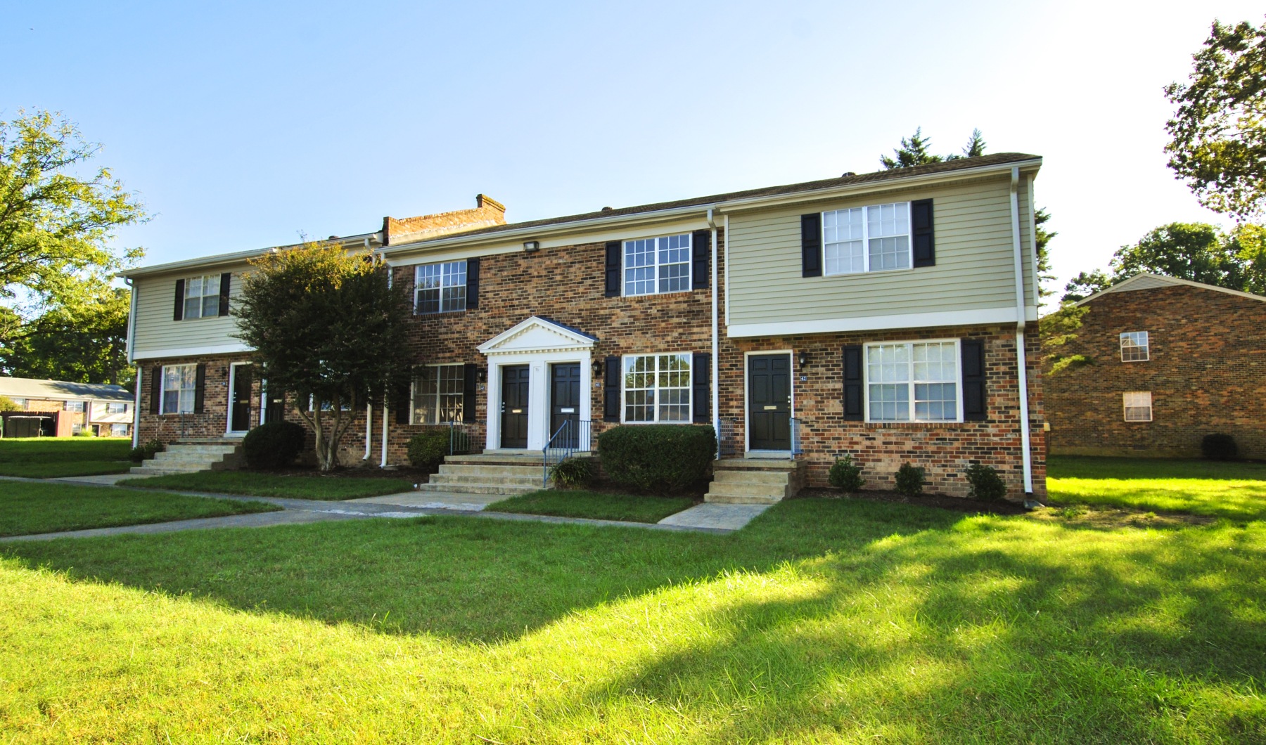 Exterior of Foxchase Brandywine Apartments featuring residential buildings and green space