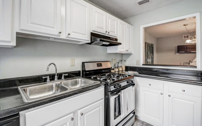 a kitchen with white cabinets and a breakfast bar