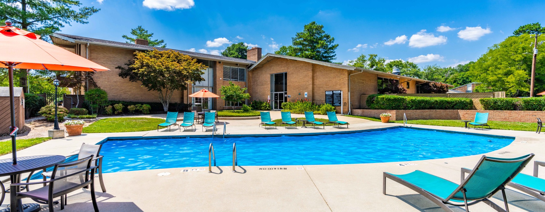 a pool with chairs and umbrella