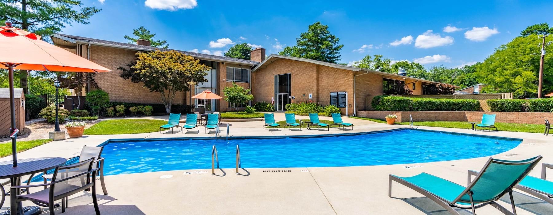 a pool with chairs and umbrella
