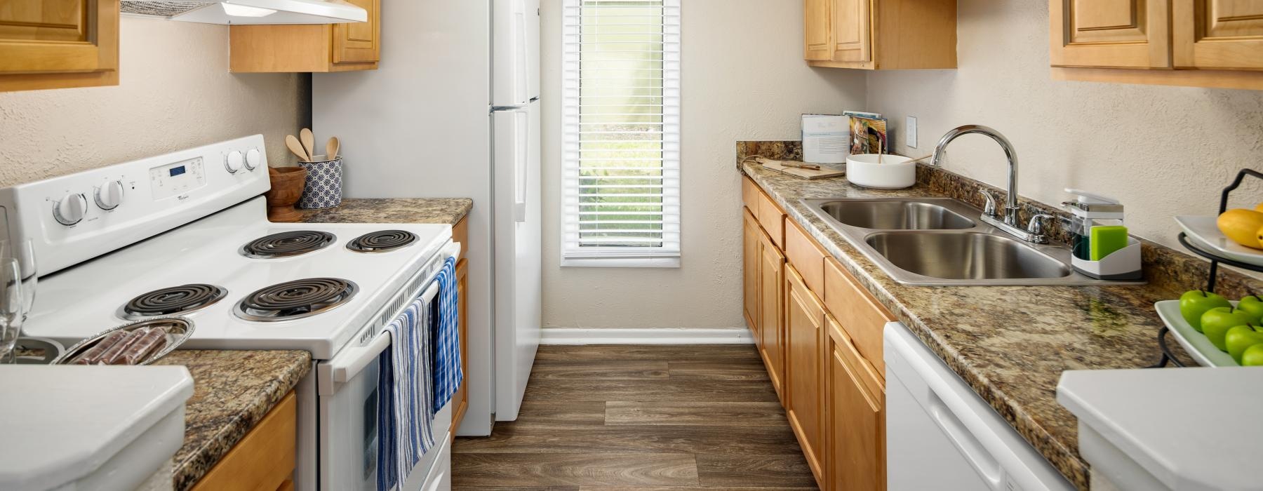 a kitchen with wooden cabinets