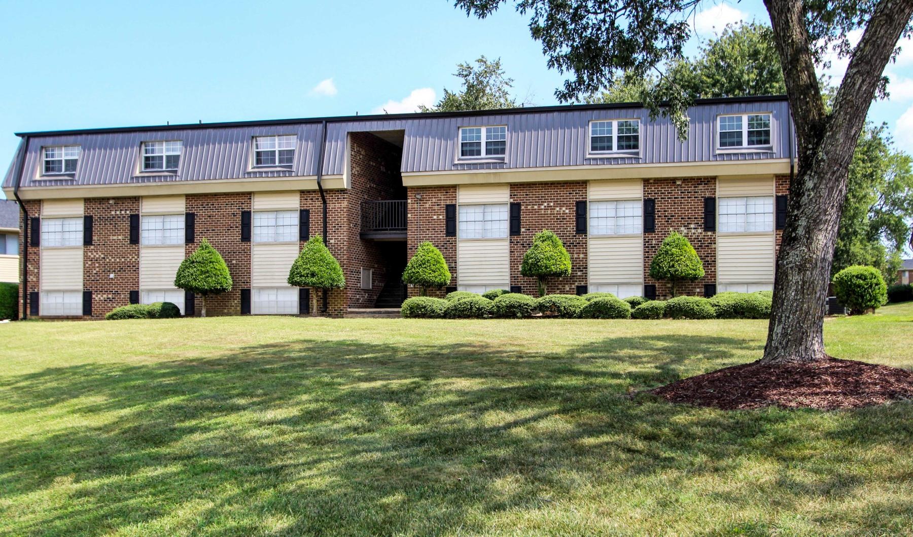 a large building with a lawn in front of it