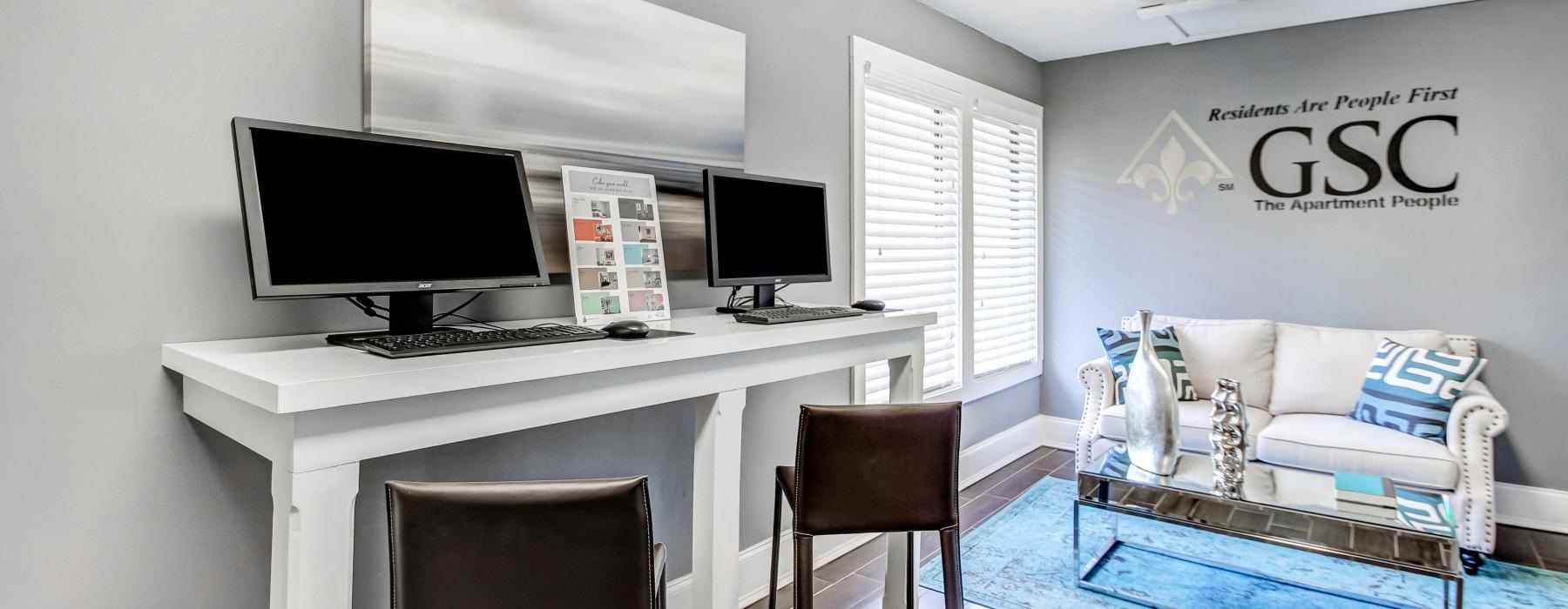 a room with a desk and computer