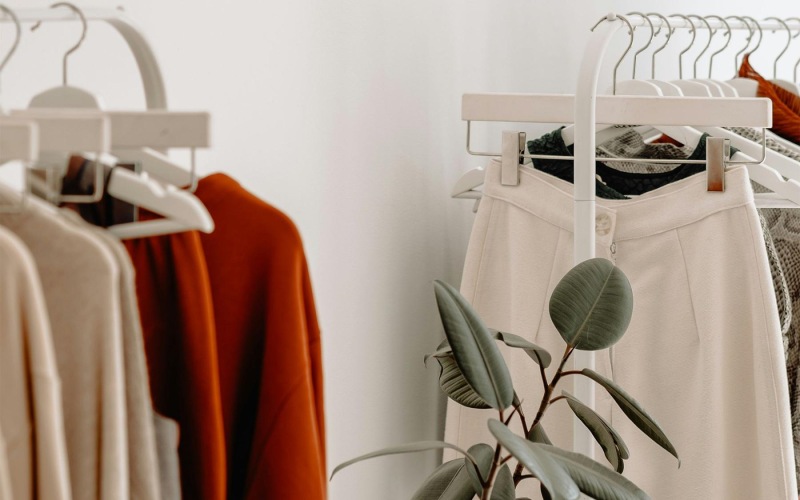 clothes on a rack near a plant