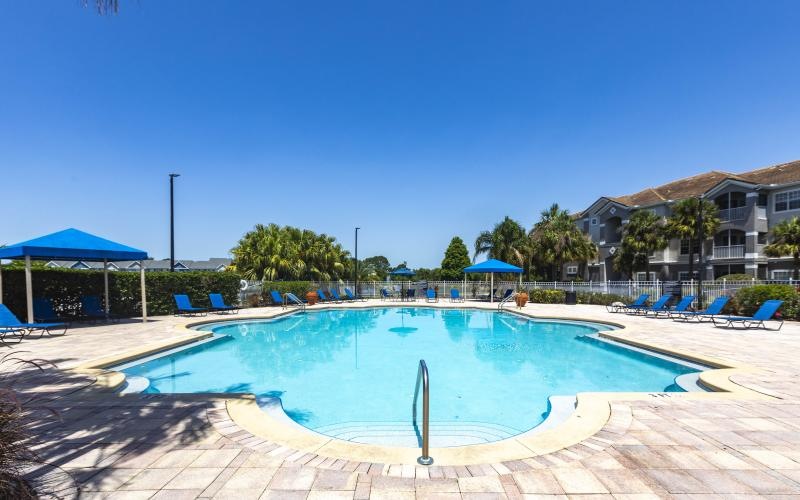 a swimming pool with chairs around it
