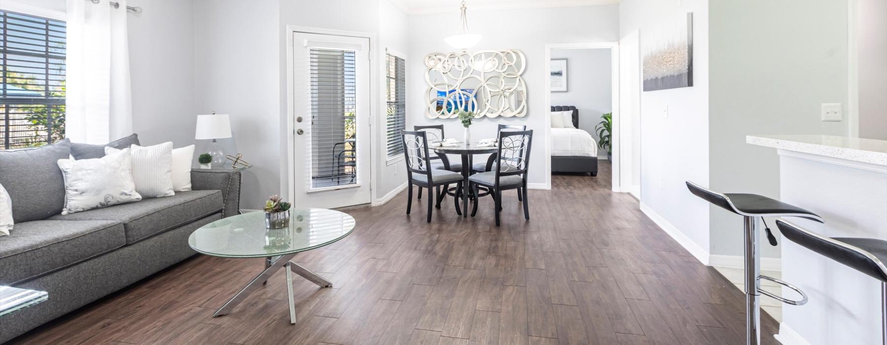 a living room with a couch, a table and chairs