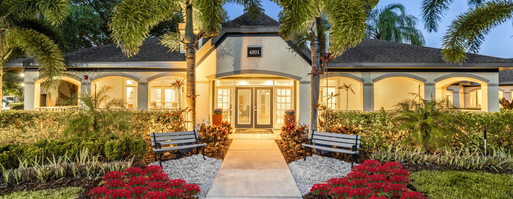 front view of a building with palm trees