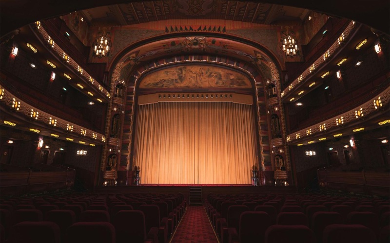 a theater with a stage and chairs