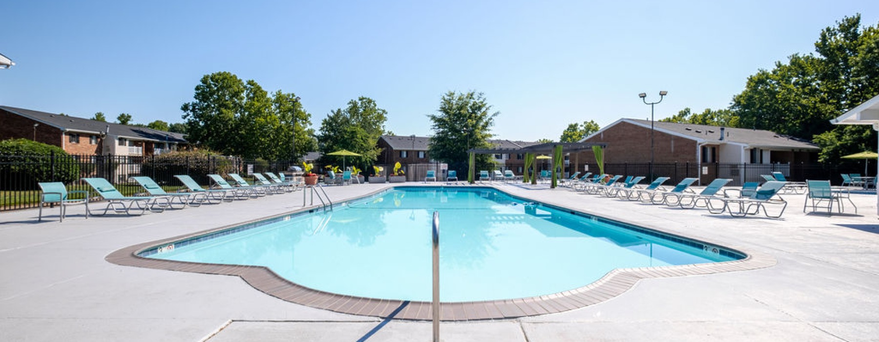 Swimming pool with lounge seating and umbrellas