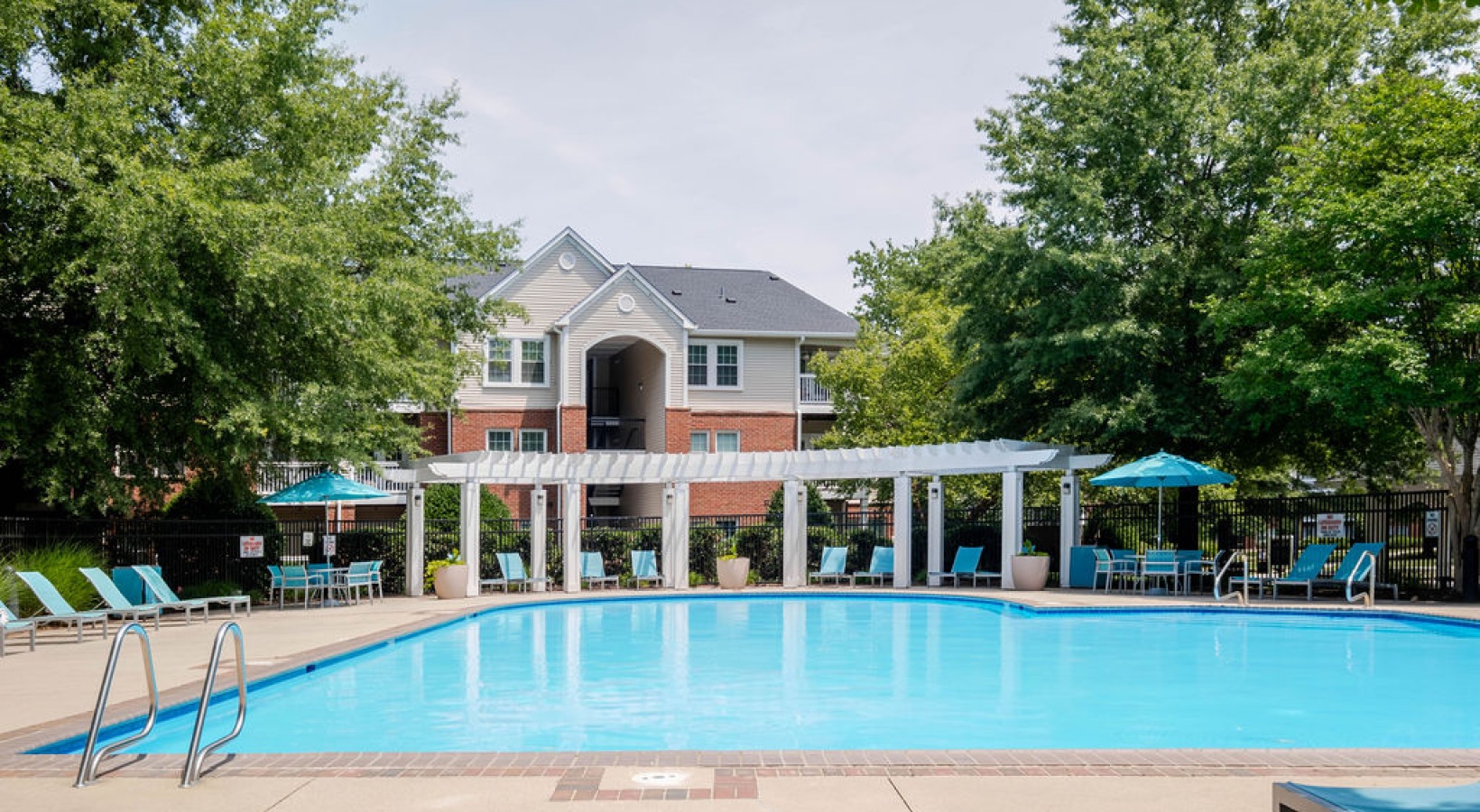 Sparkling swimming pool with lounge seating and umbrellas
