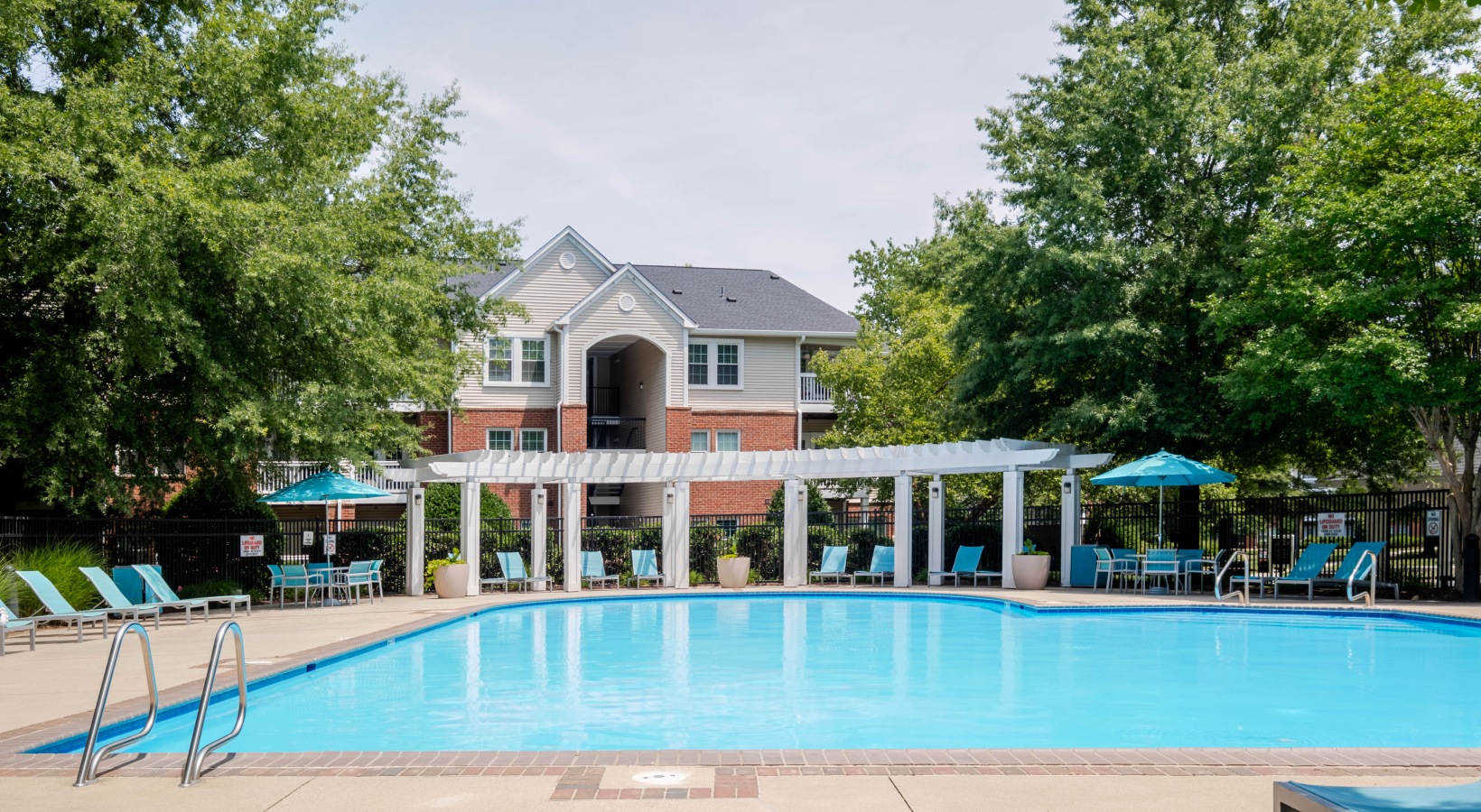 Sparkling swimming pool with lounge seating and umbrellas