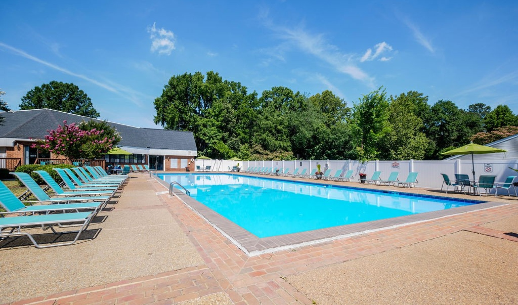 a swimming pool with lounge chairs