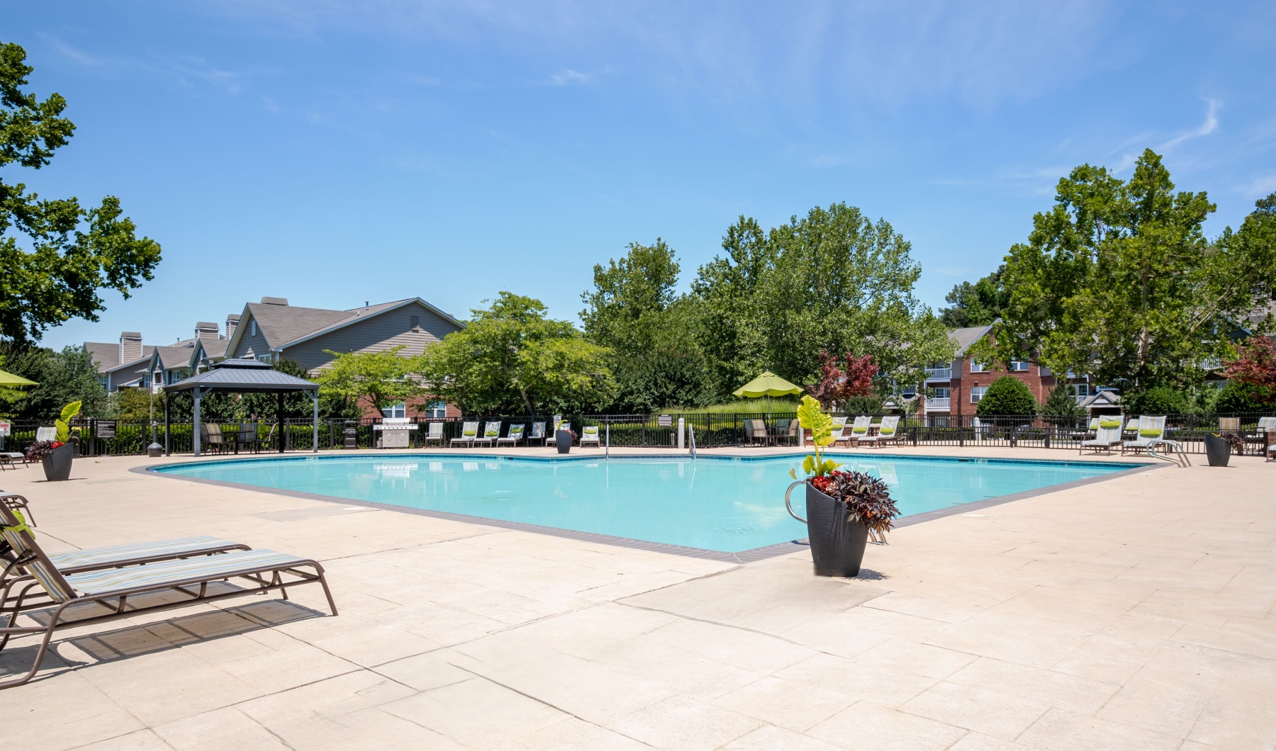 a pool with lounge chairs around it