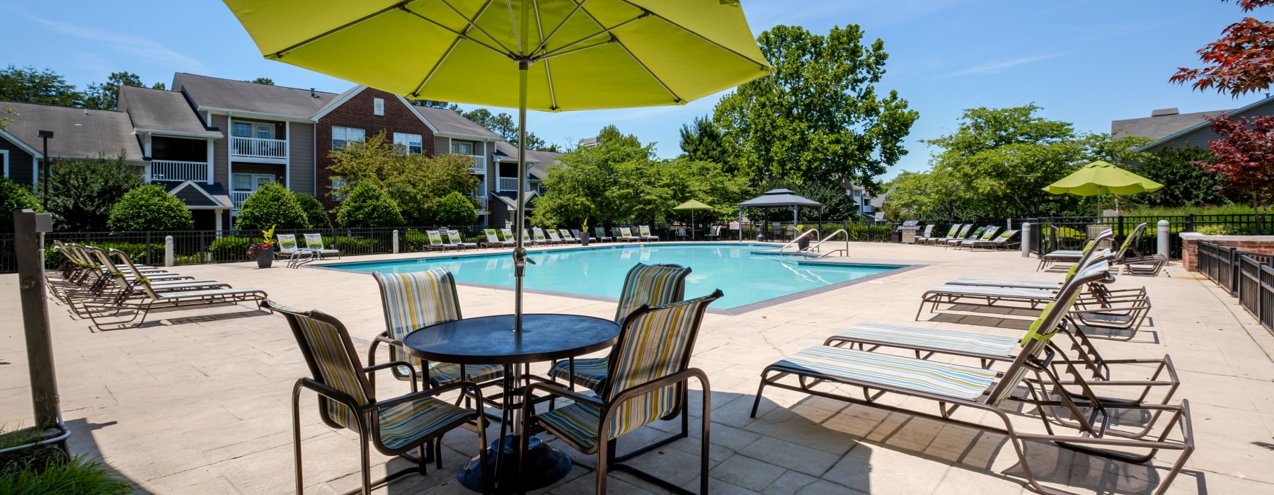 a pool with lounge chairs around it