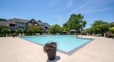Swimming pool with lounge seating and umbrellas