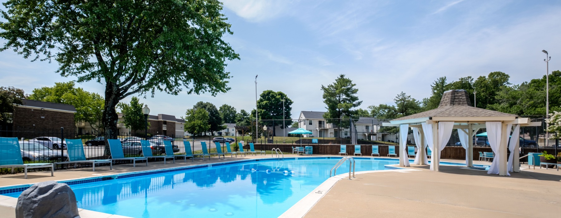Swimming pool with lounge seating and umbrellas