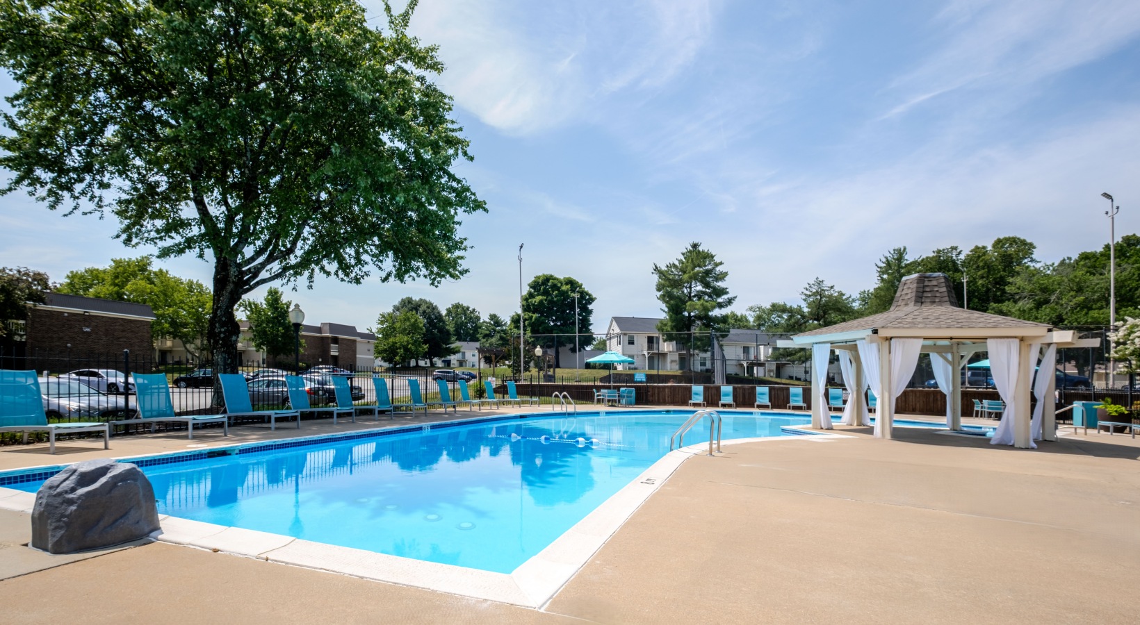 Swimming pool with lounge seating and umbrellas
