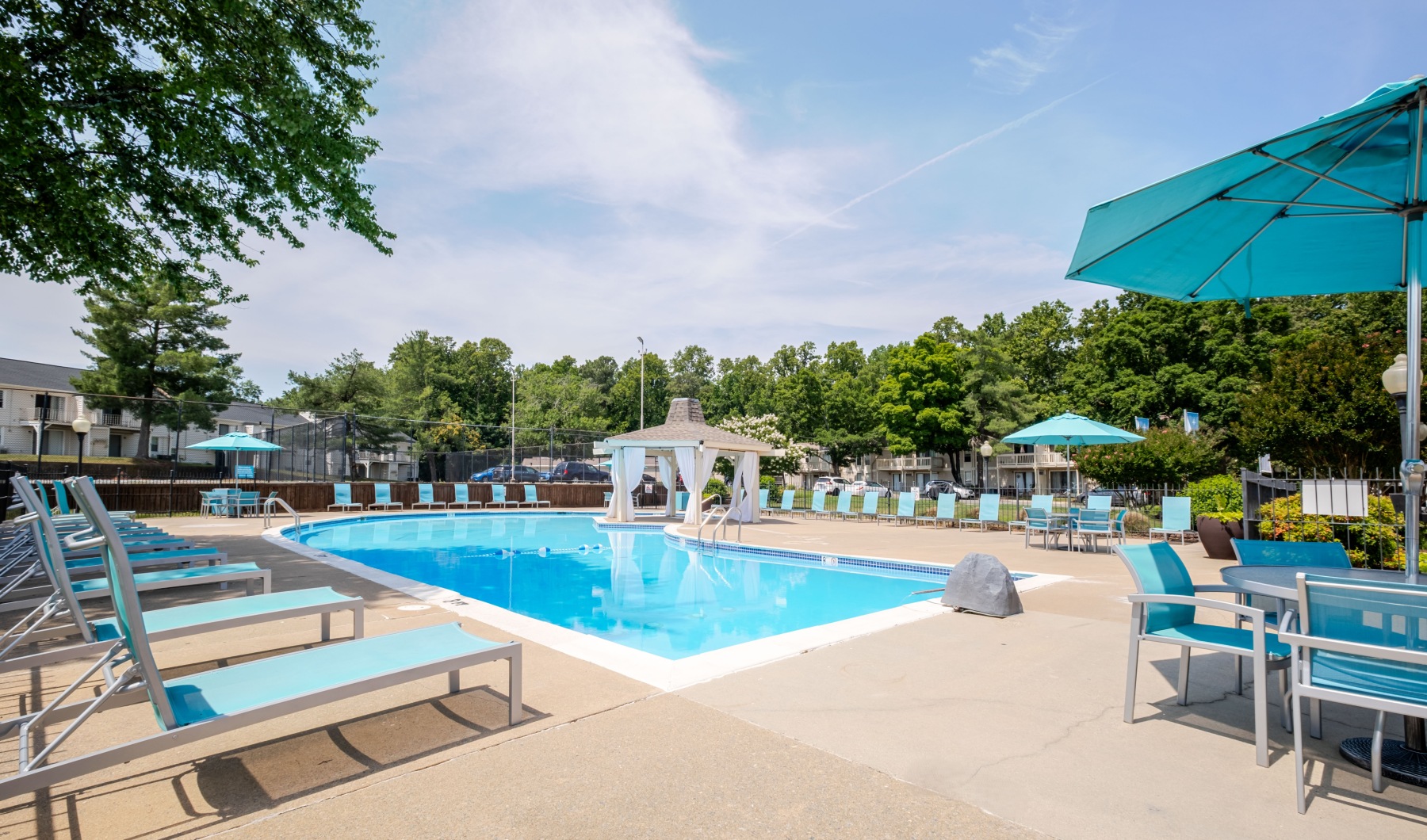 a swimming pool with lounge chairs around it