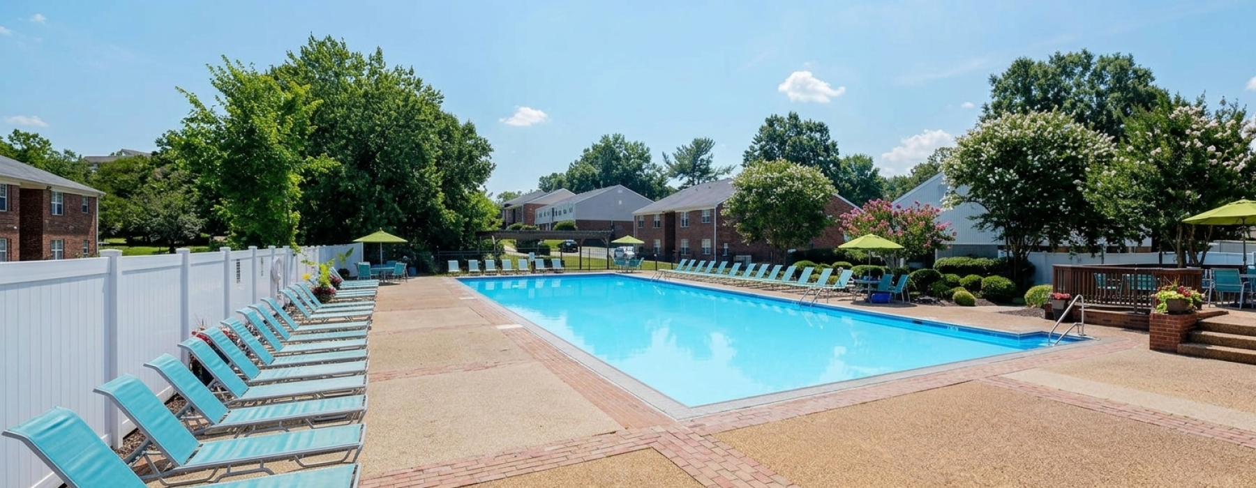 Swimming pool with lounge seating and umbrellas
