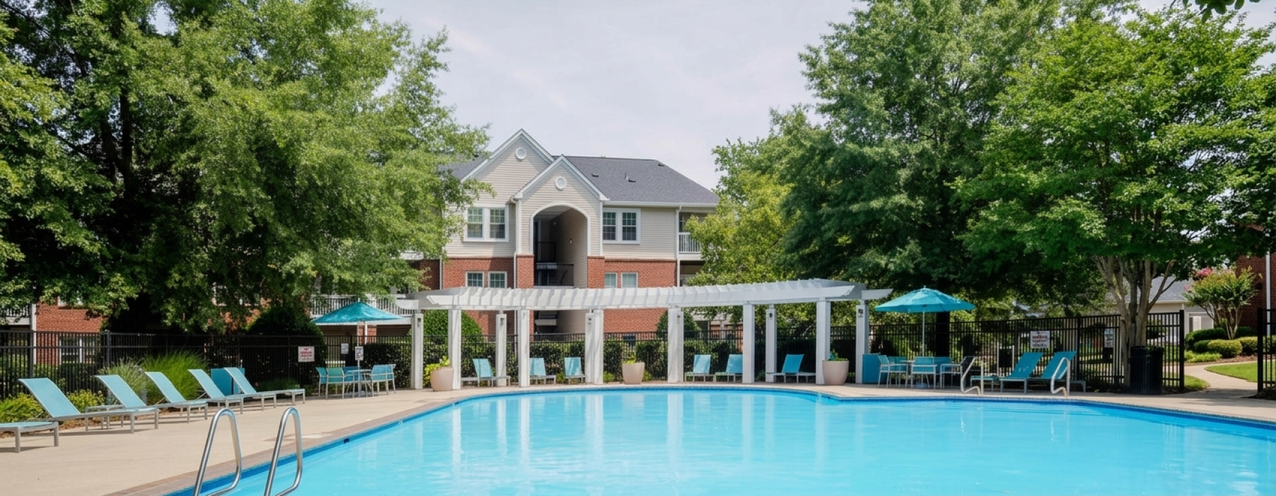 Swimming pool with lounge seating and umbrellas
