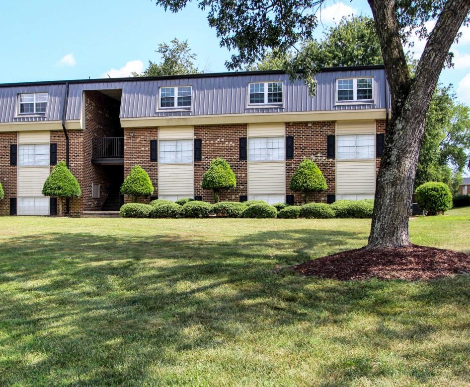 a large building with a lawn in front of it