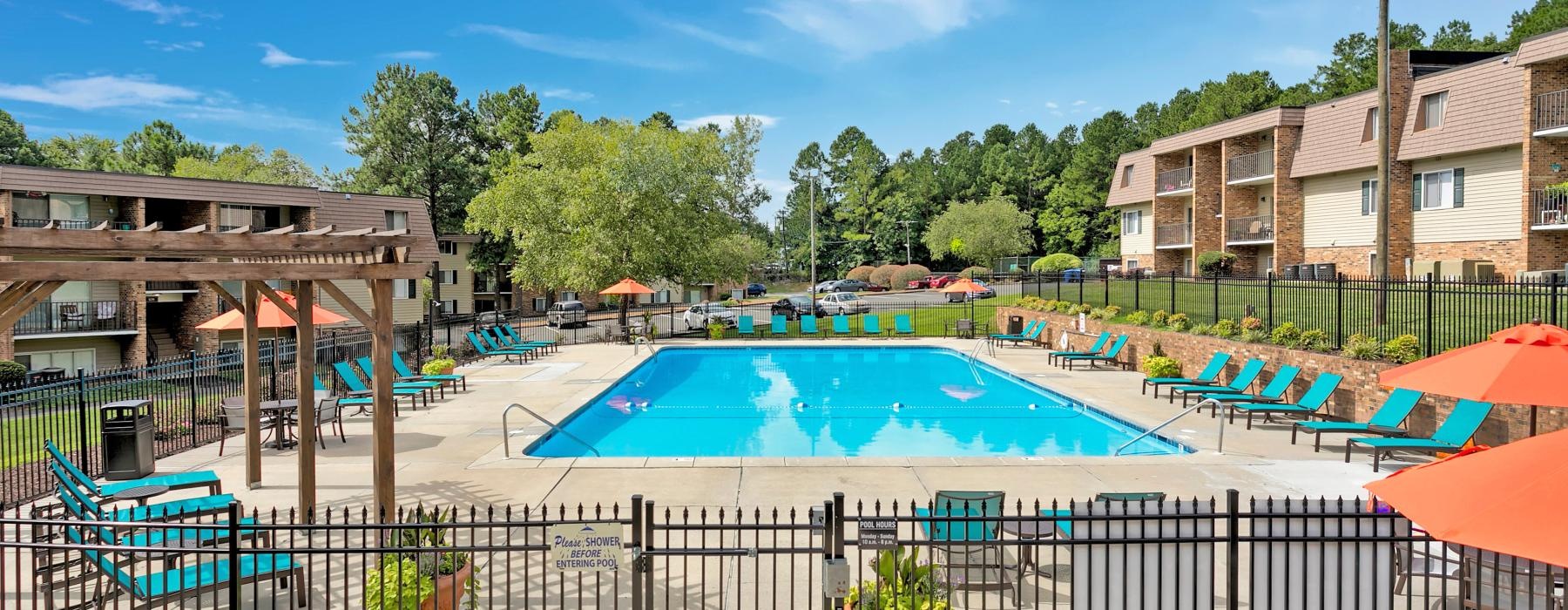 a swimming pool with chairs around it