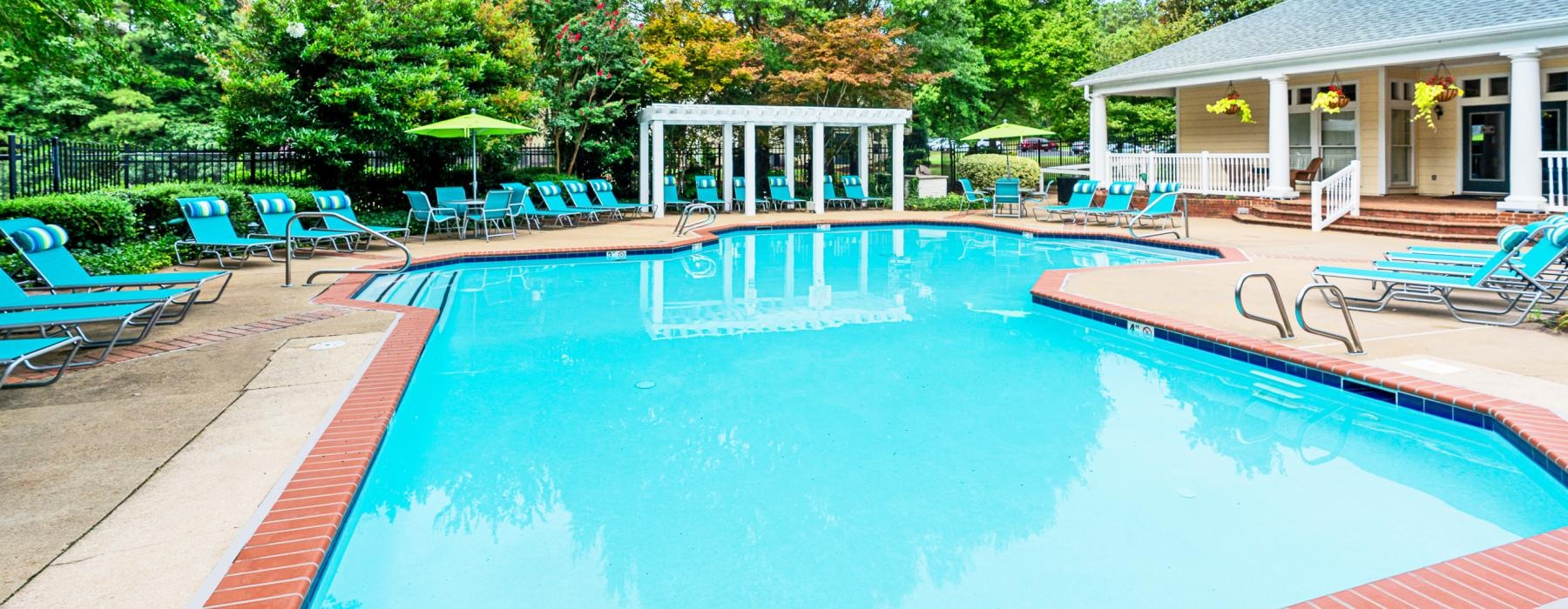 a swimming pool with chairs around it