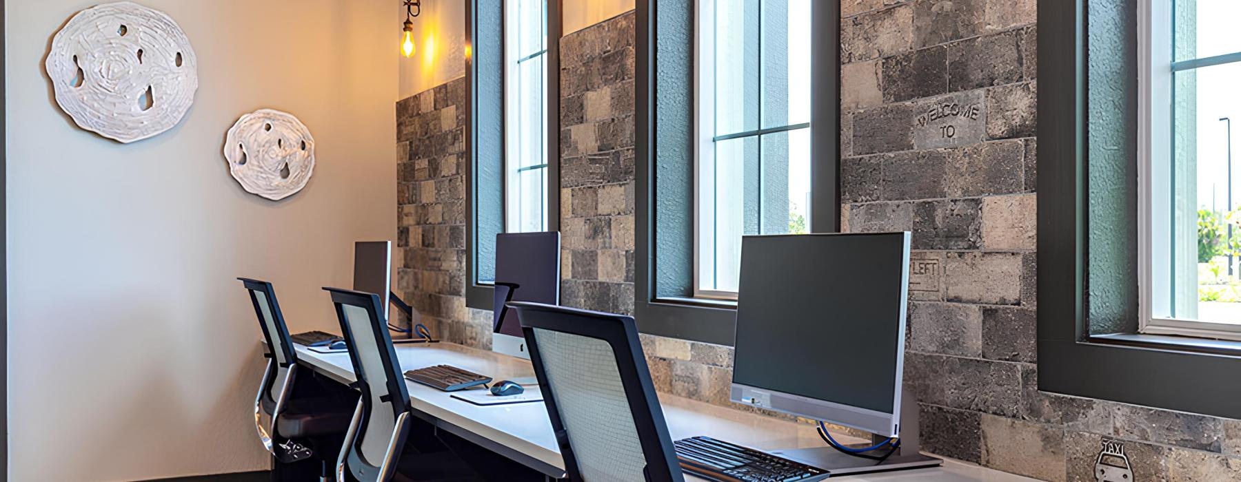 a room with a desk and computer