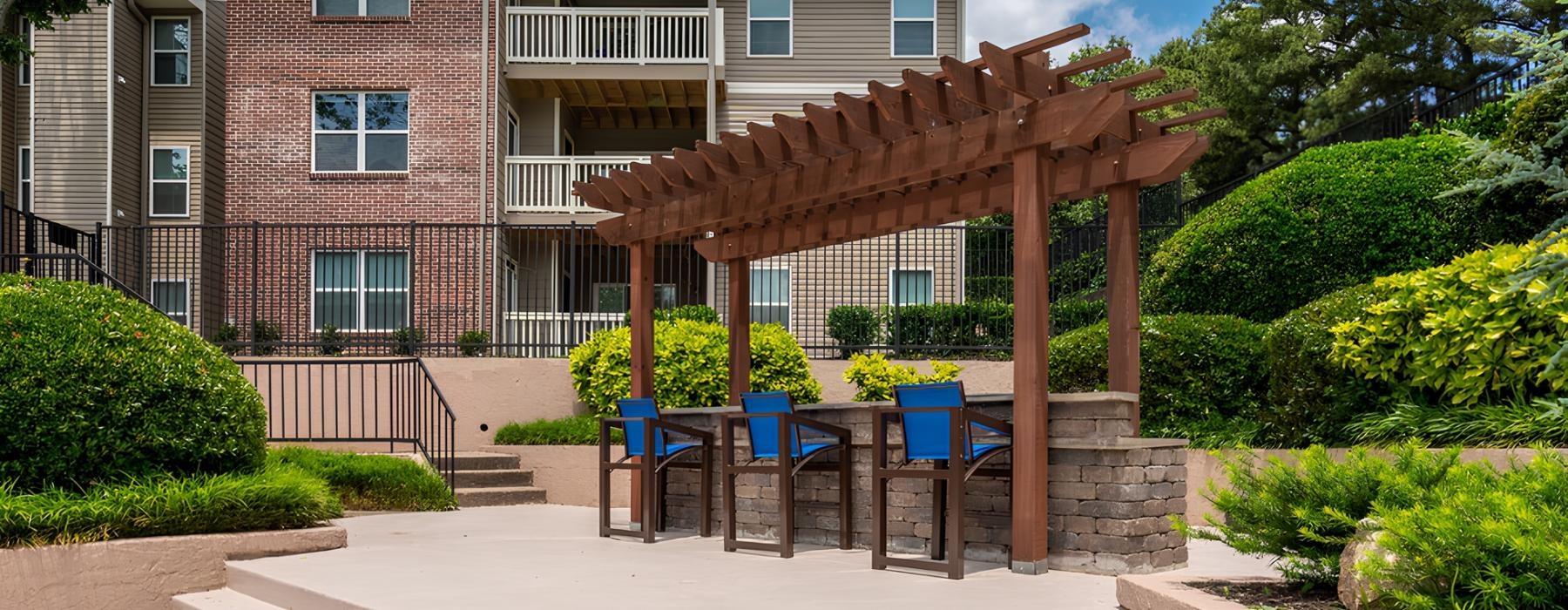 a patio with tables and chairs outside a house