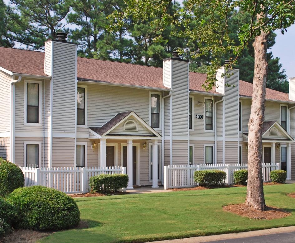 a large house with trees in the front