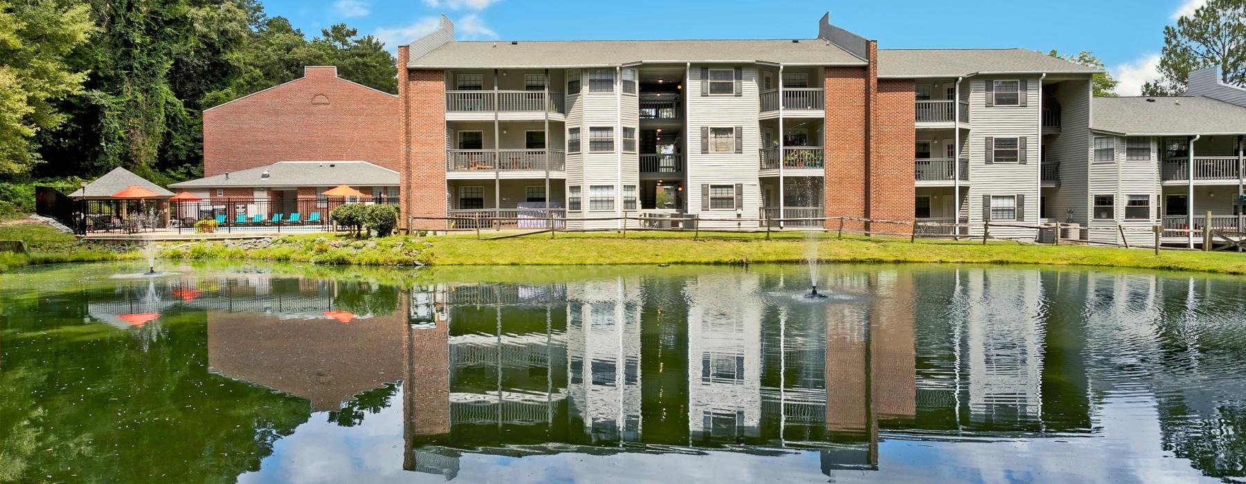 a building with a pond in front of it