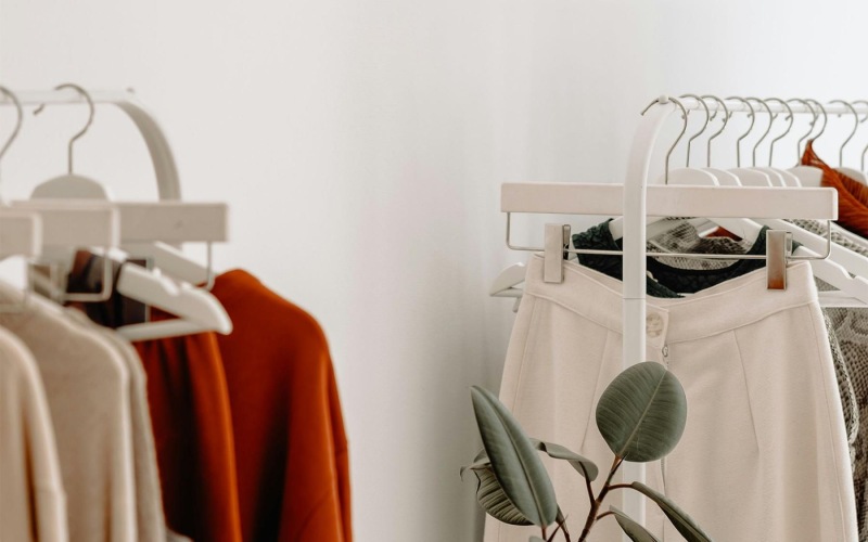 clothes on a rack near a plant