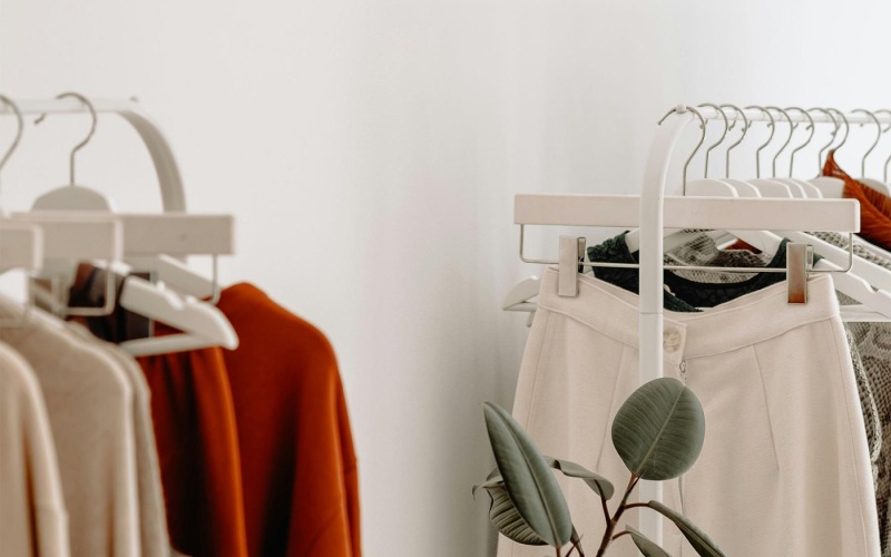 clothes on a rack near a plant