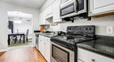 Kitchen with stainless steel appliances and built-in microwave