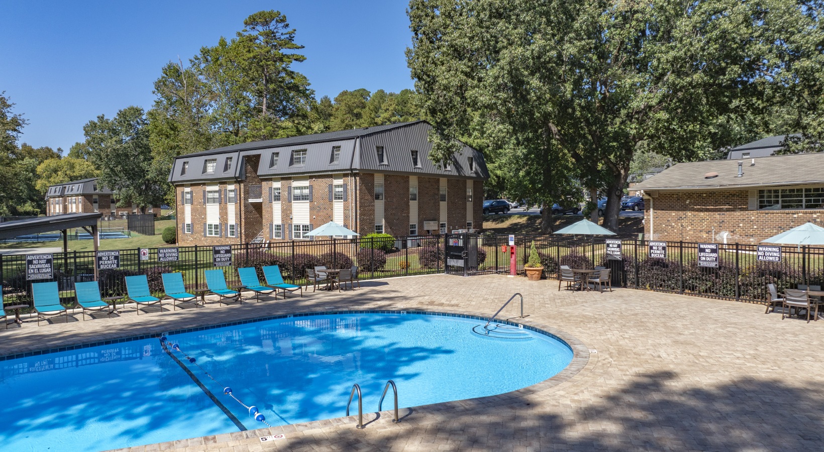 Swimming pool with lounge seating and umbrellas