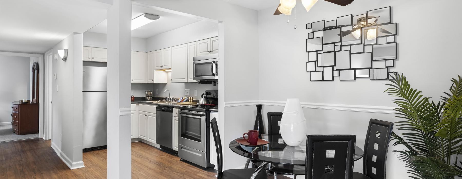 a kitchen with a fan and chairs
