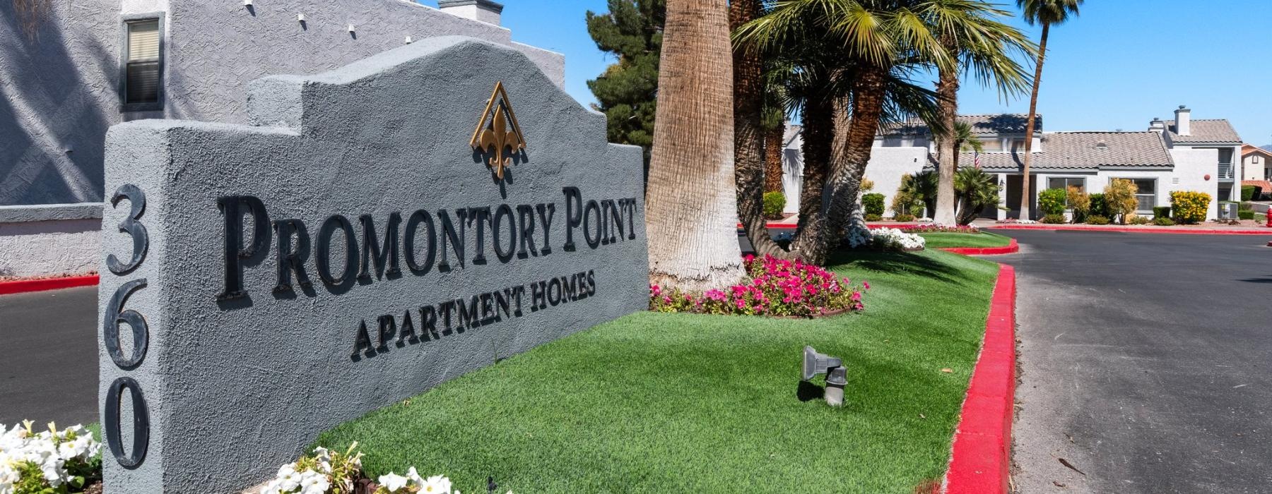 a sign at the entrance of an apartment complex