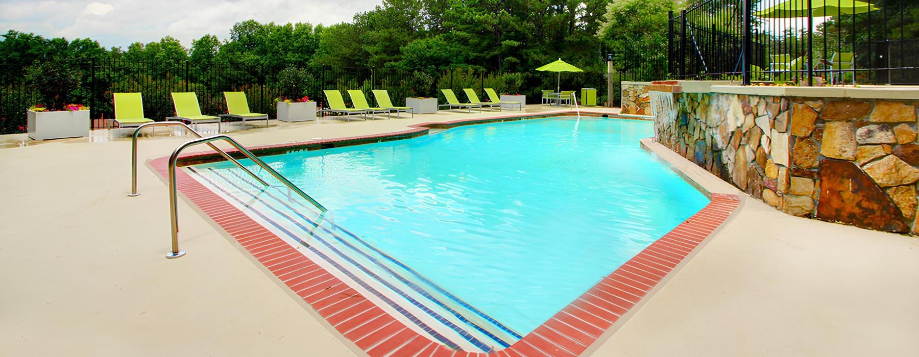 a swimming pool with chairs around it