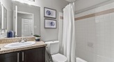 Bathroom with granite counter tops and full sized bathtubs