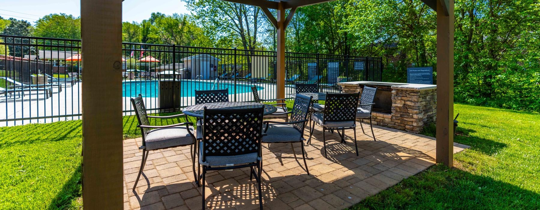 a patio with chairs and a table