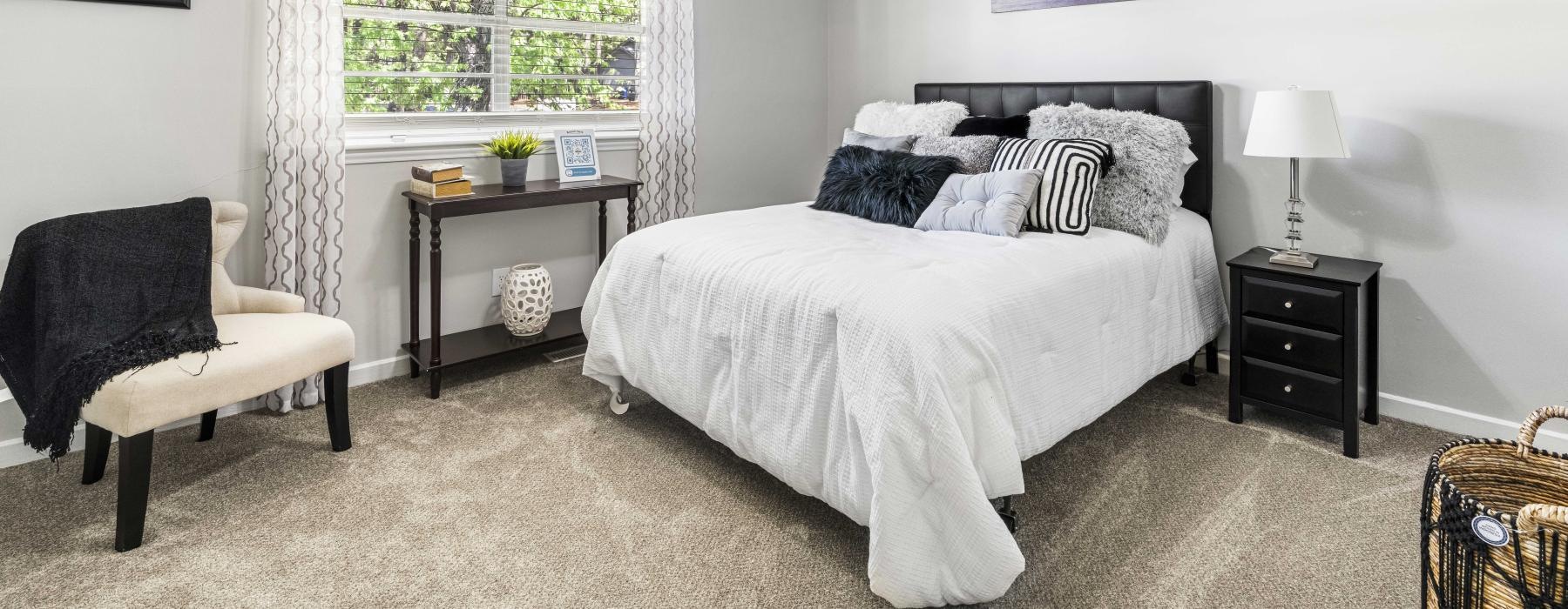 a bedroom with a bed and a fan