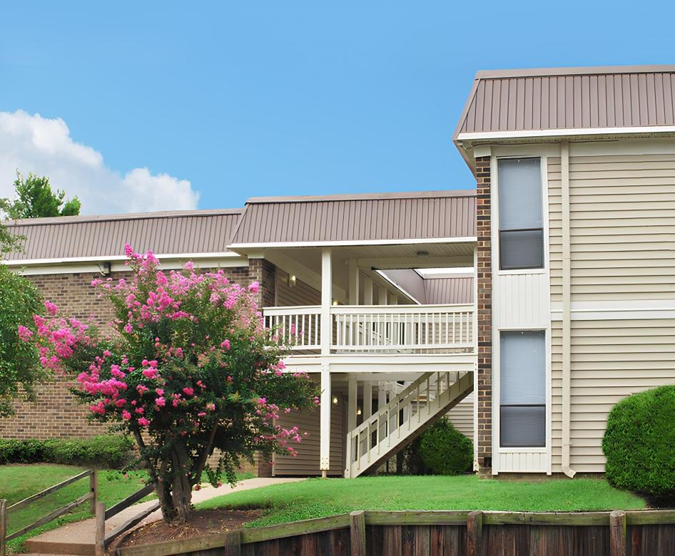 a building complex with trees in front