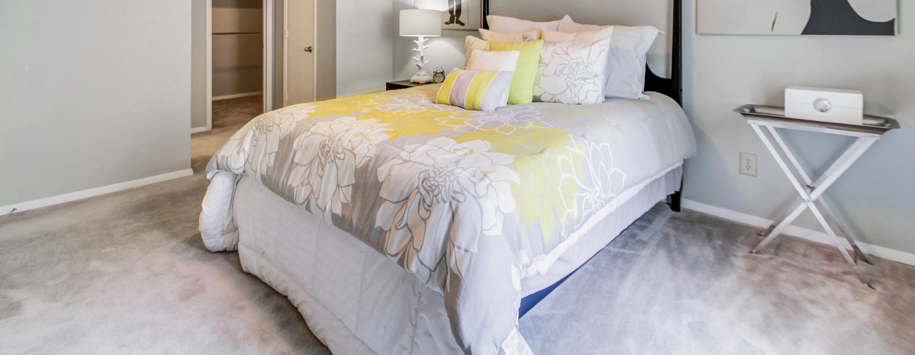 a bedroom with a bed and a side table