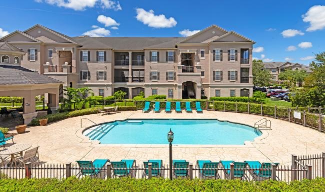 a large building with a pool in front of it
