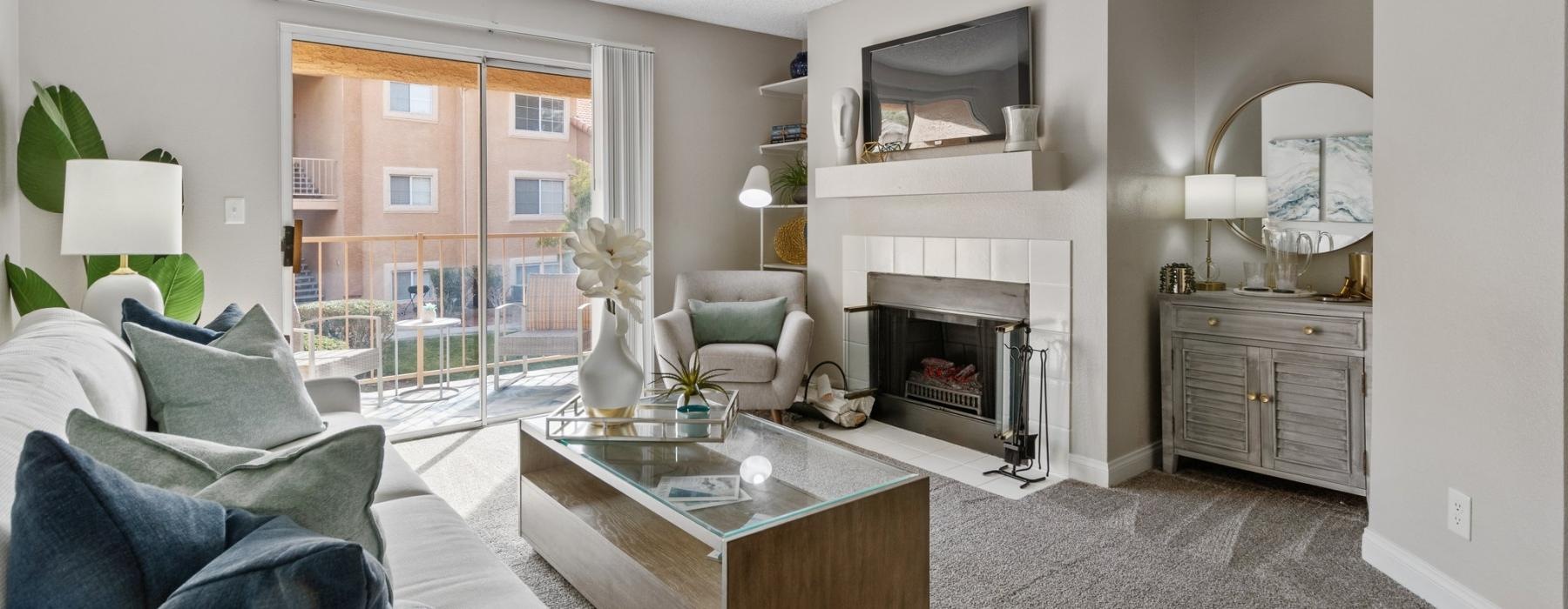 a living room with a fireplace, tv and a couch